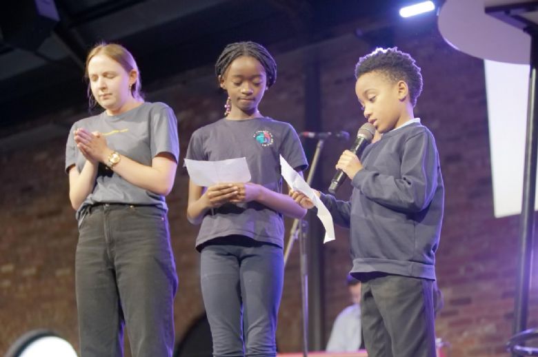 Year 6 students leading prayer in our church service